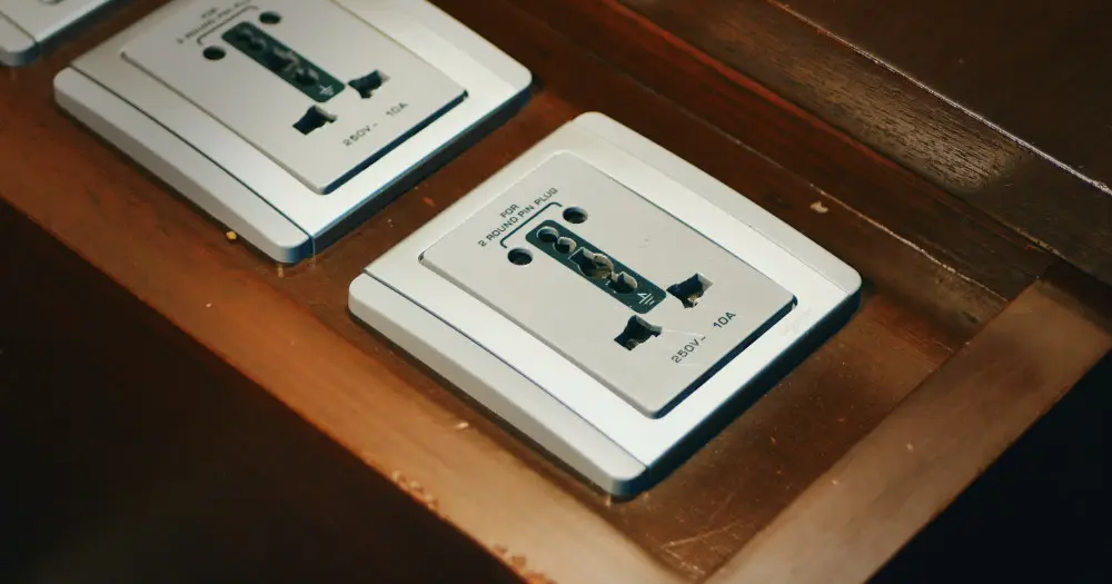 Hotel wall socket in Thailand: works with both round and flat pins.